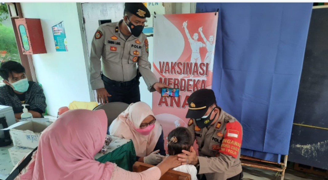 Tinjau Vaksinasi Anak Usia 6-11 Tahun, Kapolsek Kep Seribu Utara Berikan Kue Hingga Setelkan Video Kartun Ke Anak Peserta Vaksin